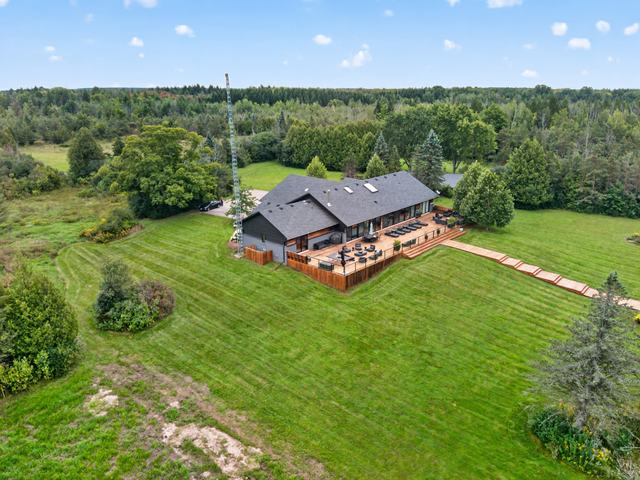 The house, deck and boardwalk from the field